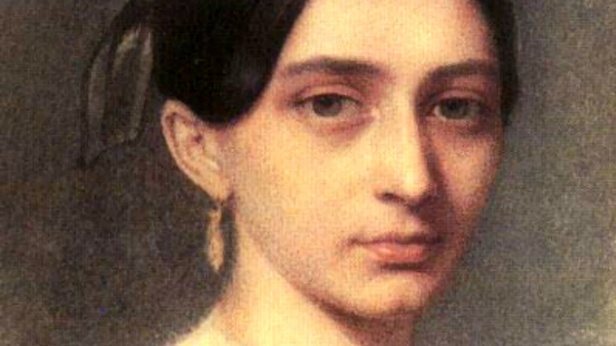 Närbild av Clara Schumanns ansikte. Hon har stora ögon, uppsatt mörkt hår och ett örhänge syns i halvprofil.