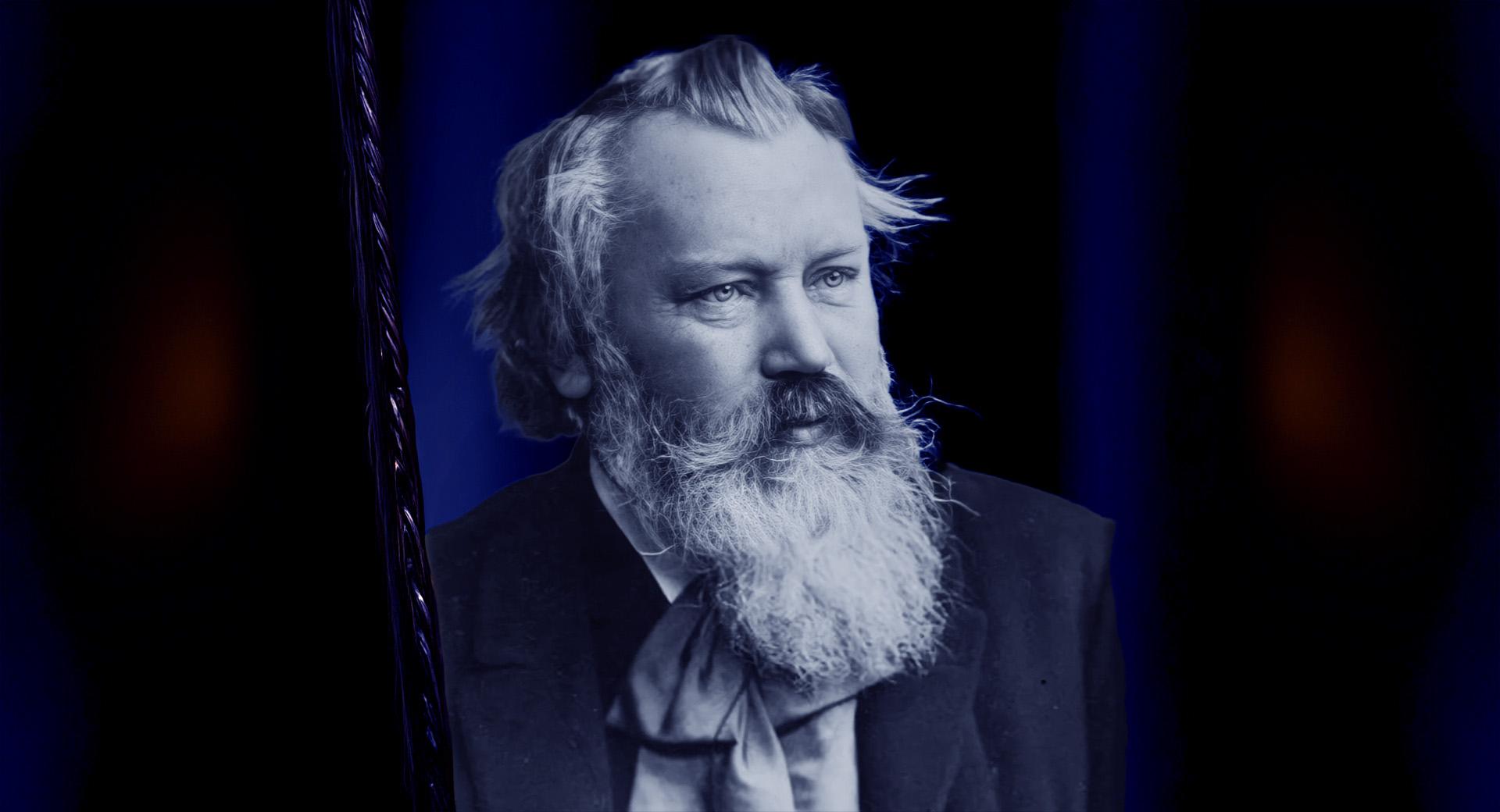 Ett utklippt svartvitt foto på Johannes Brahms på en mörkblå bakgrund.